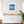 White cabinet with wooden top in a room with a framed beach scene on the wall.