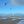 Kitesurfers on a beach with kites in the sky