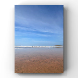 Beach scene with clear blue sky and calm water