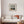 diving gannet bird and lighthouse print in wooden frame above a boho sofa