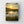 Poster of a sunrise over a marshy landscape hanging on a white brick wall.