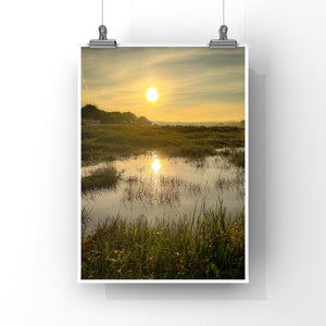 Poster of a reflected sunrise over a marshy field, displayed on a white background.