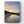 Beach scene with boats and a colorful sunrise sky reflected in water
