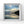 Framed artwork of a beach scene with a sunset sky reflected in wet sand