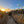 Photograph of a Sunset over a beach with a wooden fence and grassy dunes.