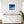 Framed beach scene art on a wall above a white cabinet with wooden top.