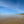 Deserted beach scene with clear blue sky and calm water
